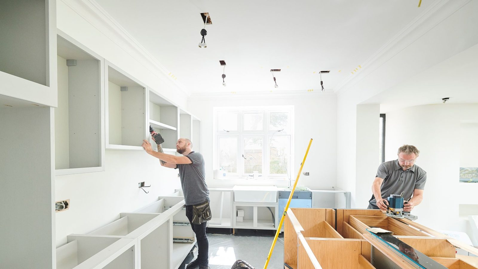 Kitchen fitters installing wall units